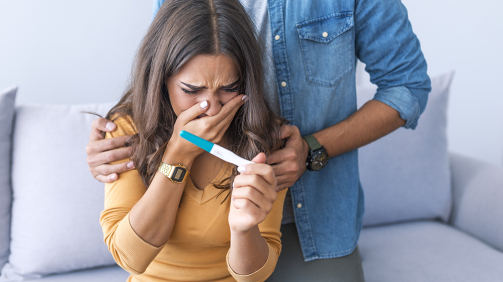 Couple deciding to abort female pregnancy. Shocked loving couple finding out about female pregnancy. Depressed couple finding out about female pregnant state