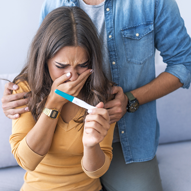 Couple deciding to abort female pregnancy. Shocked loving couple finding out about female pregnancy. Depressed couple finding out about female pregnant state