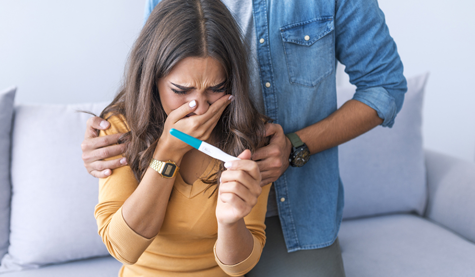 Couple deciding to abort female pregnancy. Shocked loving couple finding out about female pregnancy. Depressed couple finding out about female pregnant state